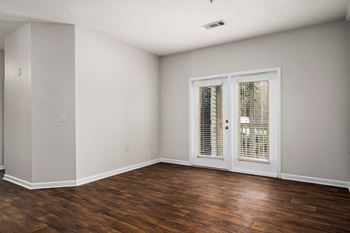 Spacious Living Area With Vinyl Plank Flooring and Patio